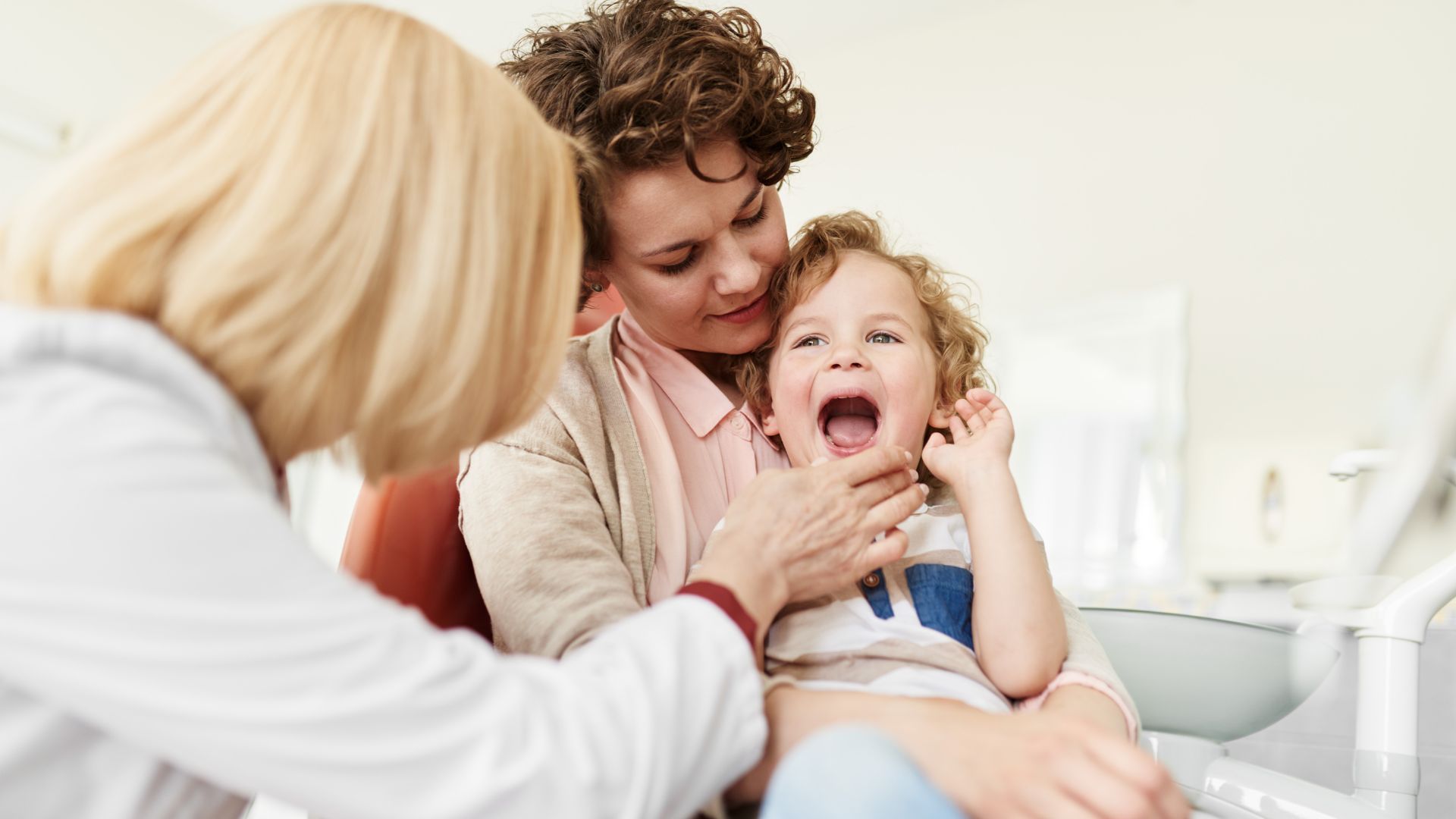 Child's dental checkup with parent present.
