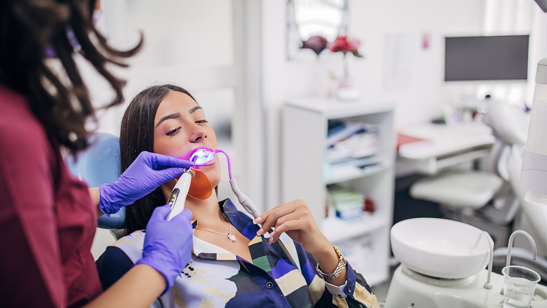Dentist performing procedure on a patient.